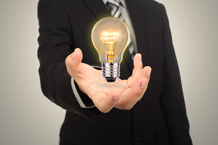 business man holding light bulb